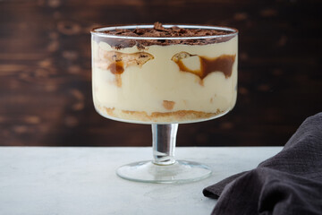 Tiramisu with caramel in a large glass.