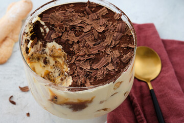 Tiramisu with caramel in a large glass.