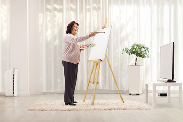 Fototapeta na wymiar Elderly woman drawing at home