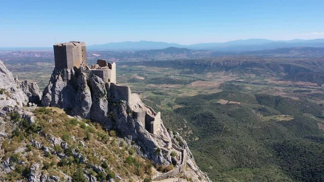 Drone view of ruins of high and isolated medieval defensive Castle de Queribus on stone peak in summer. National heritage site of France