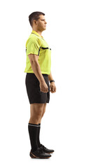 Full length profile shot of a serious footall referee