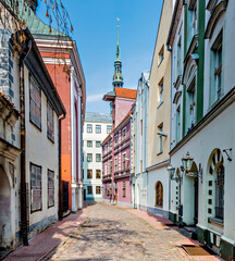 Fototapeta na wymiar Morning in medieval street of Riga - the capital of Latvia and famous tourist city in Baltic region of Europe