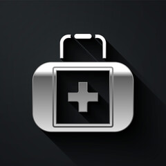 Silver First aid kit icon isolated on black background. Medical box with cross. Medical equipment for emergency. Healthcare concept. Long shadow style. Vector.