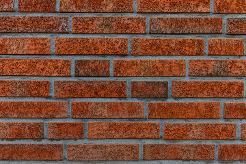 New and clean with rich colors red orange brown brick wall, clinker bricks. Brick texture