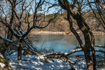 Los Arroyos Reservoir, El Escorial, Madrid. View of this frozen and snowy reservoir after the storm Filomena.