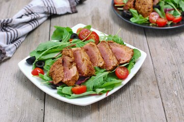 Fresh vegetable salad from tomato,lettuce, black olive with pork fillet