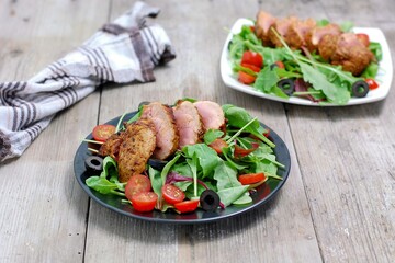 Fresh vegetable salad from tomato,lettuce, black olive with pork fillet
