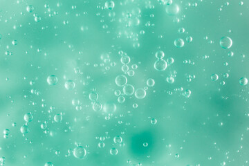 Liquid cream gel, green blue cosmetic texture with bubbles
