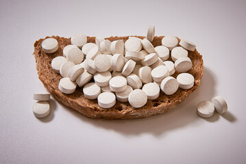 Fototapeta na wymiar sandwich with pills. health Breakfast for the treatment on the gray background. close-up, macro
