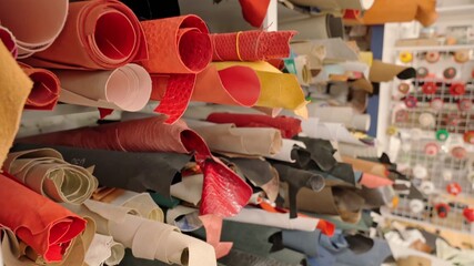 Shelves of various colorful fabric rolls at modern workshop