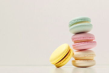 Almond cookies, in pastel colors on a white background. Traditional French multicolored dessert, close-up.