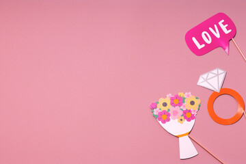 Party accessories on a pink background. Postcard concept for Valentines, Womens Day, Mens Day, Wedding Day. Flat lay, top view. Copy space.