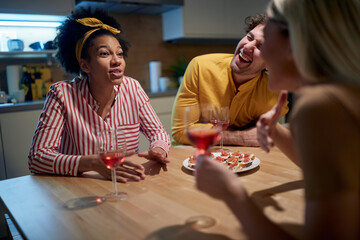 Friends having a good time at the kitchen together. Dinner, friendship, together, home