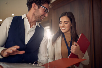 Young colleagues having conversation in the break at the conference in the hotel. Hotel, business,...