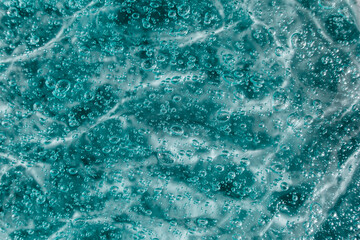 Liquid cream gel, green blue cosmetic texture with bubbles