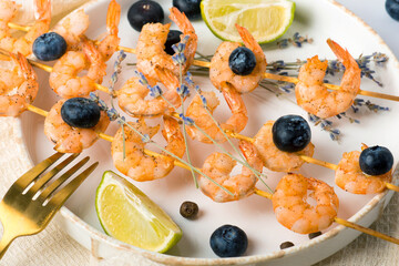 shrimp on skewers with lavender and blueberries