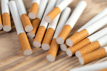 many cigarettes on a wooden background, cigarettes close up