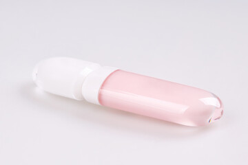  Tube of liquid lipstick gloss with applicator isolated on white background