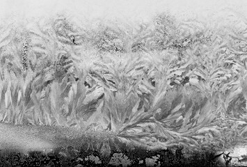Ice painting on frozen window. Winter. Close up.