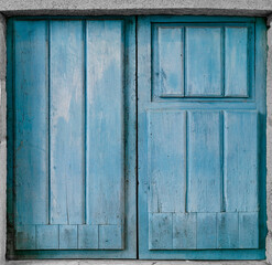 Old wooden blue door in the old stone wall