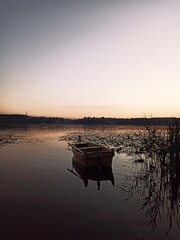 boats by the lake. pink sunset on the lake with boats