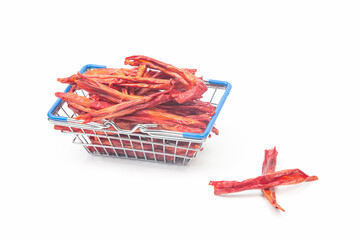 red hot dried peppers in a market basket on a white background