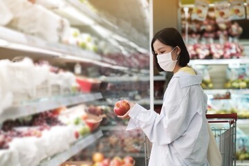 Asian women and surgical mask shopping some food in supermarket, covid-19 crisis