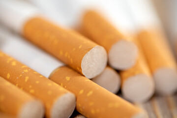 many cigarettes on a wooden background, cigarettes close up