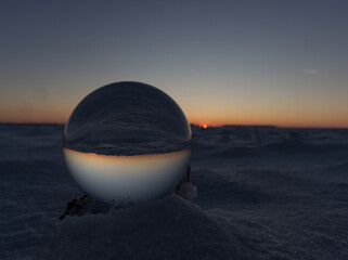 A crystal ball bottom view while sunset on snow in thuringia