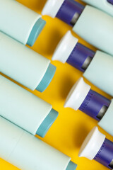 Couple of fronts and ends of syringe pens on seamless yellow background. Studio medical equipment still life concept with auto-injector disposable devices. © Maarten Zeehandelaar