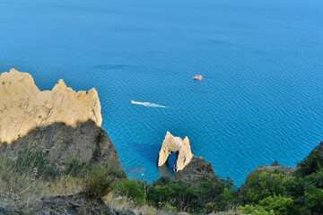 Beautiful view from the top of the cliff to the sea with a rock in the form of a gate and ships...