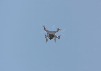 White drone flying in the sky