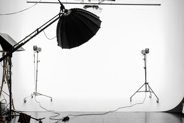 An empty photo Studio with white cyclorama. Monoblocks with flashes using softboxes of different...