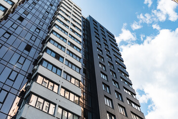 Modern Glass Building Architecture with blue sky and clouds