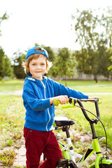 Obraz premium Portrait of a cute boy with a Bicycle.