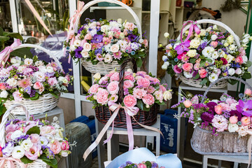 Flowers arrangement with various of colors in wicker baskets. Beautiful summer bouquet