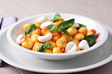 Homemade gnocchi with tomato sauce basil and mozzarella.