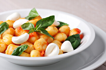 Homemade gnocchi with tomato sauce basil and mozzarella.