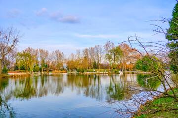 Small pond and lake with its reflection of the trees  during sunset in botanical park Bursa. 
