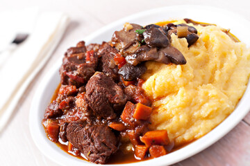 Delicious beef stew with mushrooms and polenta. High quality photo