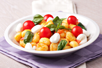 Homemade gnocchi with tomato sauce basil and mozzarella.