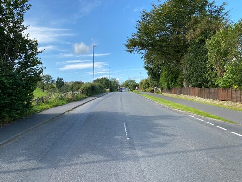 Looking along, Hawksworth Lane, on a sunny afternoon in, Guiseley, Leeds, UK
