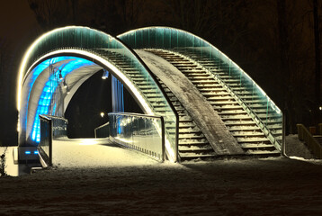 The bridge in the Ludowy Park in Lublin, illuminated by LED light - blue - obrazy, fototapety, plakaty