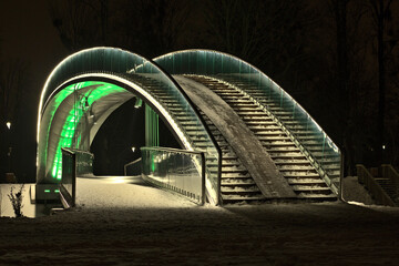 The bridge in the People's Park in Lublin illuminated with LED light - green - obrazy, fototapety, plakaty