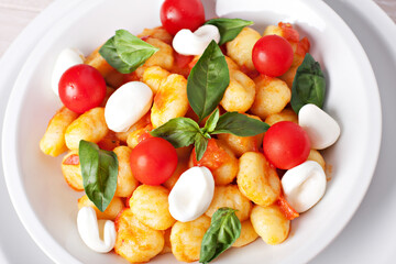 Homemade gnocchi with tomato sauce basil and mozzarella.