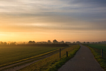 Fototapeta na wymiar famous dutch cycling path early in the morning at sunrise