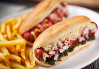 Hotdog with fries, sauce and french fries. High quality photo.