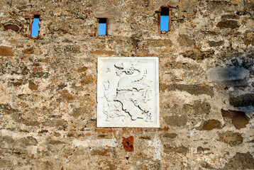 Coat of arms of the Appiani family at the entrance of the medieval town of Populonia,  municipality of Piombino, Tuscany, Italy.