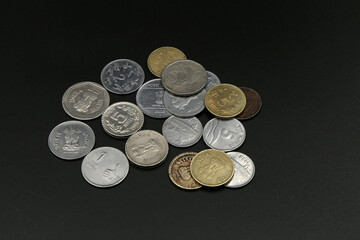 Old coins from India on black background