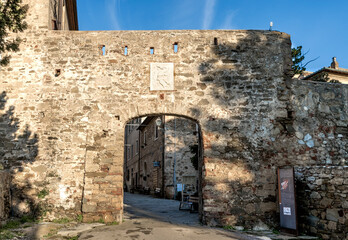 The entrance of the medieval town of Populonia with the coat of Arms of the Appiani family, municipality of Piombino, Tuscany, Italy. 